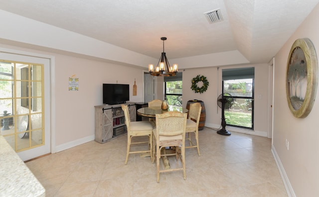 dining room with a chandelier, light tile patterned floors, and baseboards