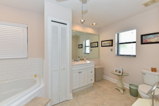 bathroom featuring a closet, toilet, a bath, healthy amount of natural light, and recessed lighting