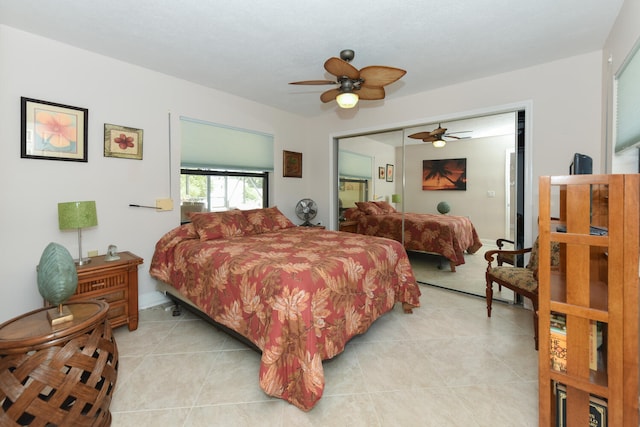 bedroom with light tile patterned flooring, a ceiling fan, and a closet