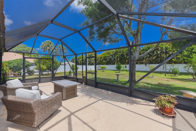 view of patio with glass enclosure and a water view