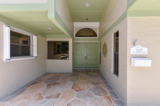entrance to property featuring stucco siding