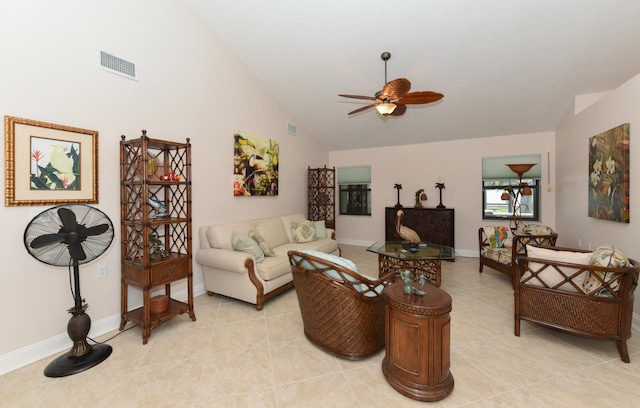 living area featuring ceiling fan, high vaulted ceiling, light tile patterned floors, and baseboards