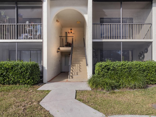 doorway to property featuring stucco siding