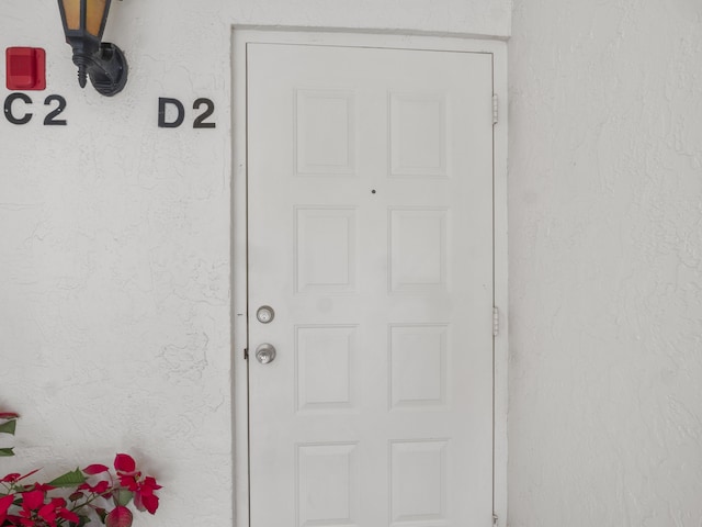 property entrance featuring stucco siding