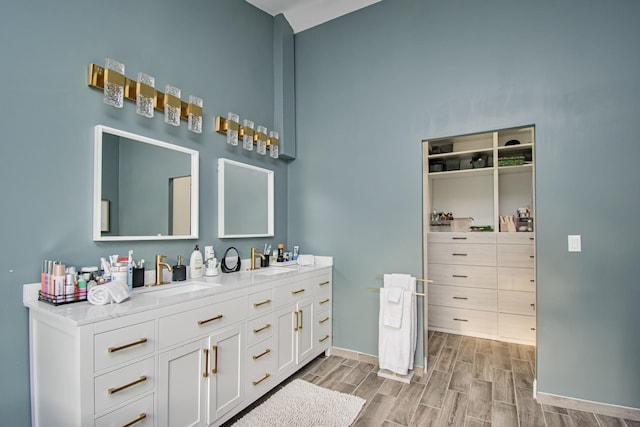 23319 Mirabella Cir N, Boca Raton, FL 33433 - full bathroom featuring double vanity, baseboards, a sink, and wood finished floors