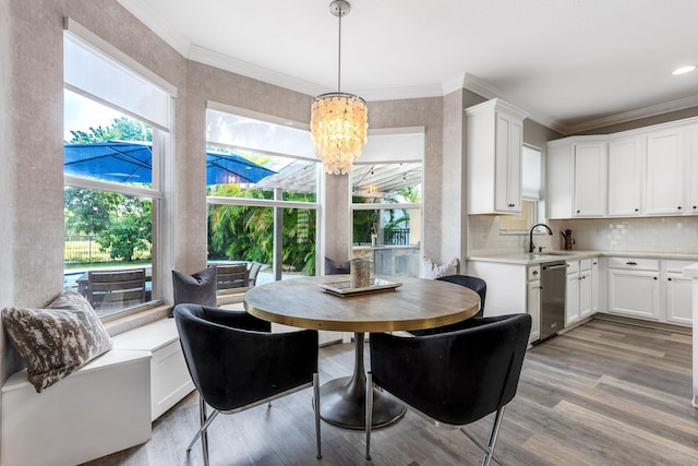 8533 Briar Rose Pt, Boynton Beach, FL 33473 - dining area featuring a chandelier, light wood-type flooring, and ornamental molding