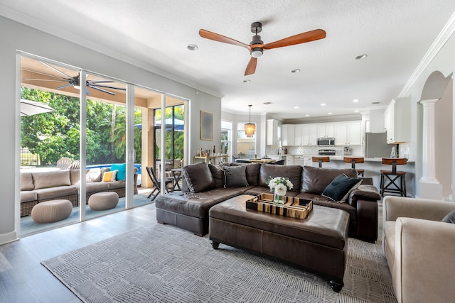 8533 Briar Rose Pt, Boynton Beach, FL 33473 - living room featuring a ceiling fan, ornamental molding, wood finished floors, recessed lighting, and ornate columns