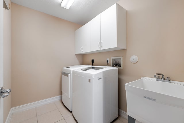 8533 Briar Rose Pt, Boynton Beach, FL 33473 - laundry room featuring cabinet space, baseboards, washer and clothes dryer, and light tile patterned flooring