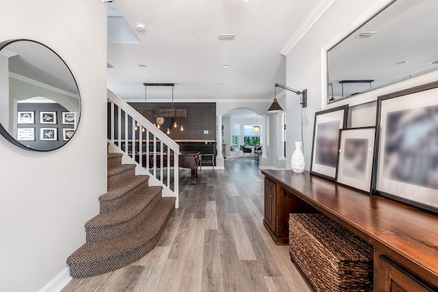 8533 Briar Rose Pt, Boynton Beach, FL 33473 - entryway featuring wood finished floors, crown molding, arched walkways, baseboards, and recessed lighting