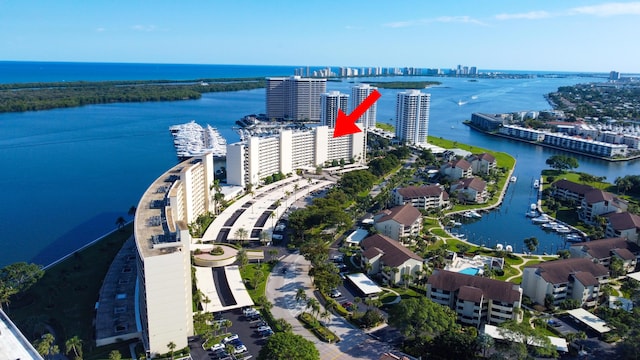 birds eye view of property with a view of city and a water view