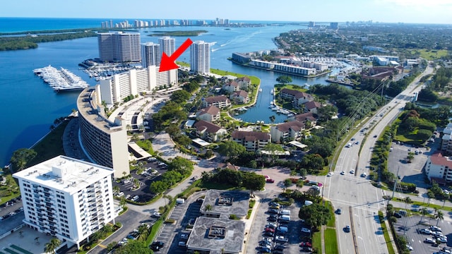 drone / aerial view featuring a view of city and a water view