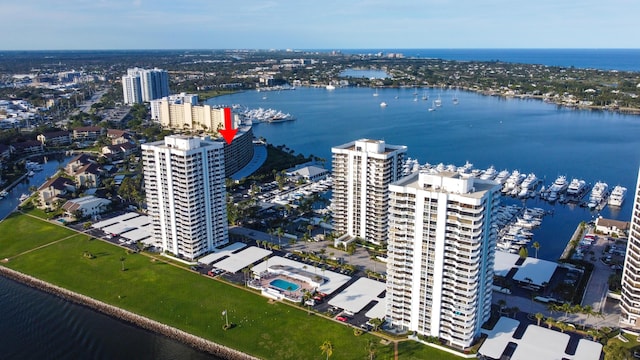 drone / aerial view featuring a city view and a water view
