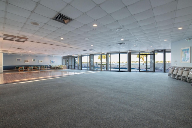 interior space featuring recessed lighting, a paneled ceiling, visible vents, and floor to ceiling windows