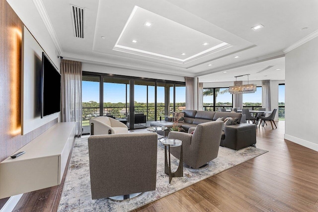 7383 Orangewood Ln Unit 304, Boca Raton, FL 33433 - living room featuring healthy amount of natural light, wood finished floors, crown molding, a chandelier, and recessed lighting