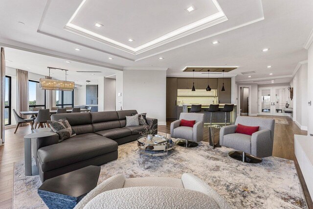 7383 Orangewood Ln Unit 304, Boca Raton, FL 33433 - living area with wood finished floors, a tray ceiling, crown molding, recessed lighting, and baseboards