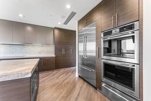 7383 Orangewood Ln Unit 304, Boca Raton, FL 33433 - kitchen with stainless steel appliances, modern cabinets, light countertops, a warming drawer, and light wood-style flooring