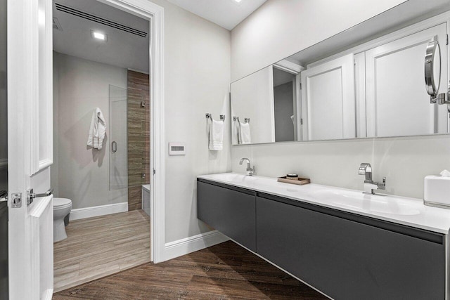 7383 Orangewood Ln Unit 304, Boca Raton, FL 33433 - full bath with an enclosed shower, baseboards, wood finished floors, toilet, and double vanity