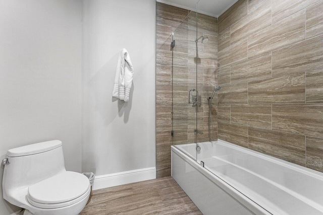 7383 Orangewood Ln Unit 304, Boca Raton, FL 33433 - bathroom featuring baseboards, combined bath / shower with glass door, toilet, and wood finished floors