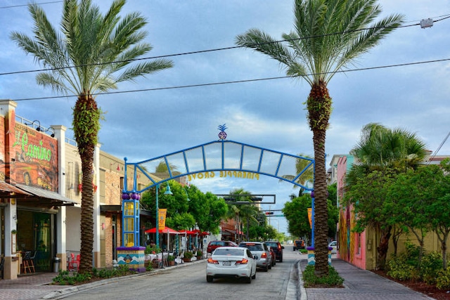 829 Camino Rd Unit 112-B, Delray Beach, FL 33445 - view of asphalt road with sidewalks, curbs, street lights, and traffic lights