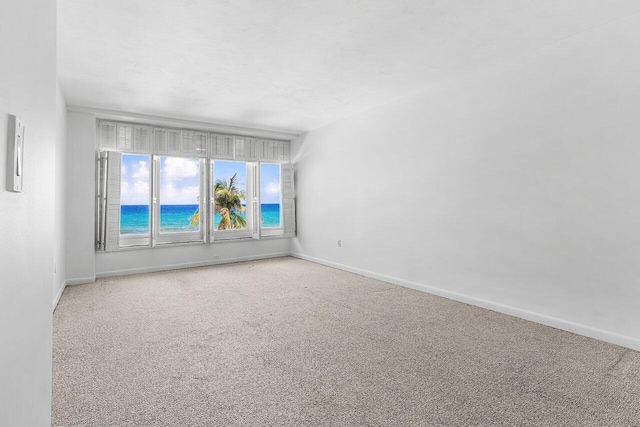 1225 S Ocean Blvd Unit 302, Delray Beach, FL 33483 - empty room featuring carpet flooring and a water view