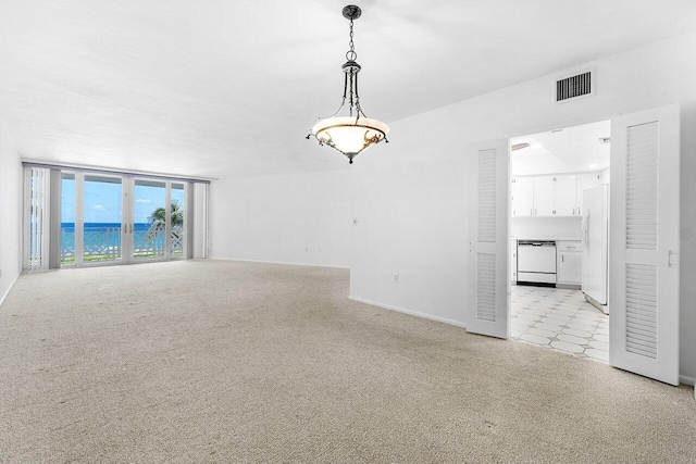 1225 S Ocean Blvd Unit 302, Delray Beach, FL 33483 - empty room featuring a water view and light colored carpet