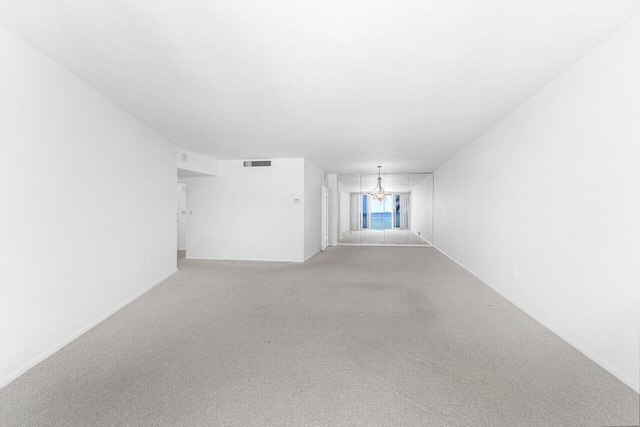 1225 S Ocean Blvd Unit 302, Delray Beach, FL 33483 - unfurnished room with light carpet and a chandelier