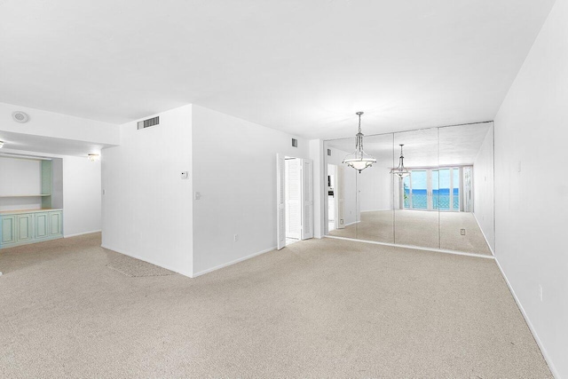 1225 S Ocean Blvd Unit 302, Delray Beach, FL 33483 - empty room featuring light colored carpet and a chandelier
