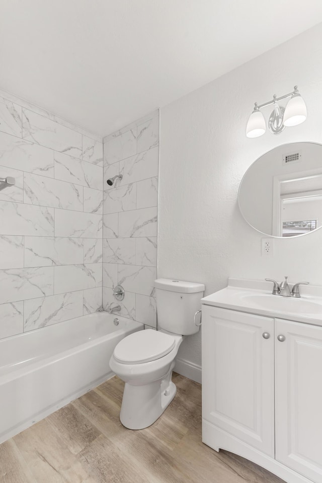 full bath featuring wood finished floors, visible vents, toilet, vanity, and  shower combination