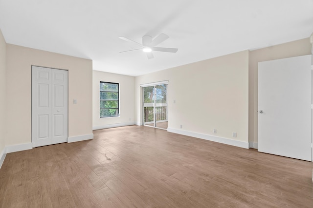 7350 Kinghurst Dr Unit 305, Delray Beach, FL 33446 - unfurnished bedroom featuring a ceiling fan, light wood finished floors, baseboards, and access to outside