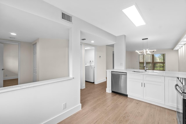 7350 Kinghurst Dr Unit 305, Delray Beach, FL 33446 - kitchen featuring a sink, visible vents, white cabinetry, washer / clothes dryer, and appliances with stainless steel finishes