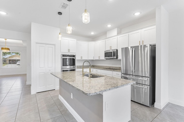 2132 SW Vista Rd, Port Saint Lucie, FL 34953 - kitchen featuring white cabinets, a sink, appliances with stainless steel finishes, baseboards, and light tile patterned flooring