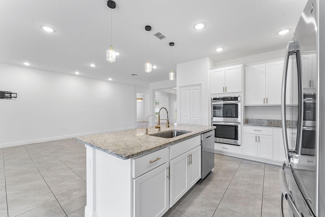 2132 SW Vista Rd, Port Saint Lucie, FL 34953 - kitchen featuring stainless steel appliances, light tile patterned floors, a sink, white cabinetry, and visible vents