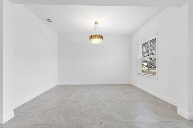 2132 SW Vista Rd, Port Saint Lucie, FL 34953 - spare room featuring light tile patterned floors, a notable chandelier, baseboards, and visible vents