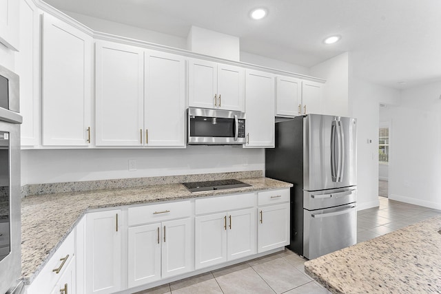 2132 SW Vista Rd, Port Saint Lucie, FL 34953 - kitchen with recessed lighting, light stone counters, light tile patterned floors, stainless steel appliances, and white cabinetry