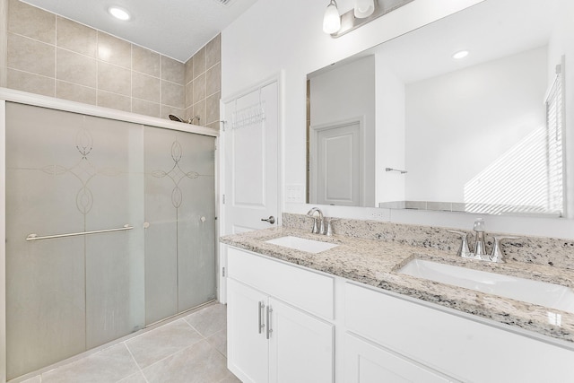 2132 SW Vista Rd, Port Saint Lucie, FL 34953 - bathroom with tile patterned floors, a stall shower, double vanity, and a sink