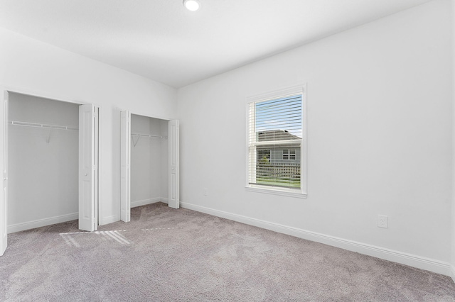 2132 SW Vista Rd, Port Saint Lucie, FL 34953 - unfurnished bedroom featuring baseboards, carpet floors, and multiple closets