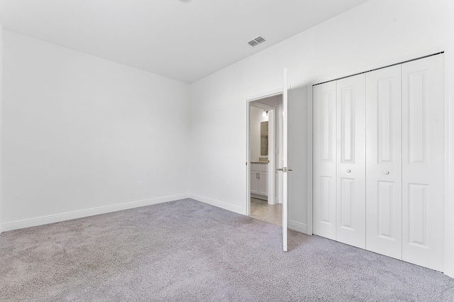 2132 SW Vista Rd, Port Saint Lucie, FL 34953 - unfurnished bedroom with a closet, carpet flooring, baseboards, and visible vents