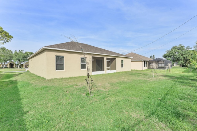 2132 SW Vista Rd, Port Saint Lucie, FL 34953 - back of property featuring a yard, stucco siding, and roof with shingles