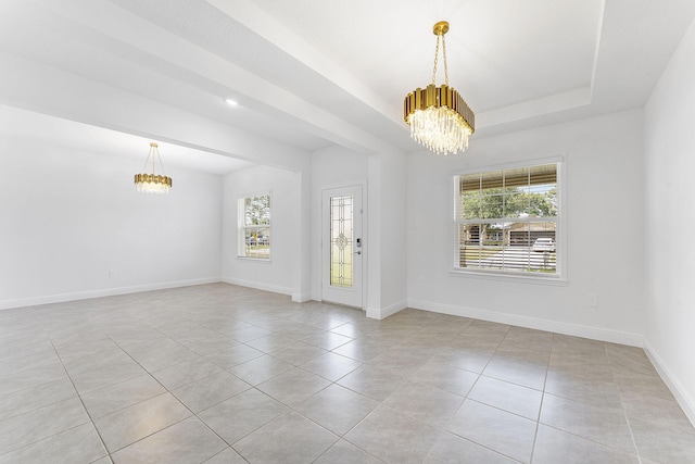 2132 SW Vista Rd, Port Saint Lucie, FL 34953 - unfurnished room featuring baseboards, light tile patterned floors, and a notable chandelier