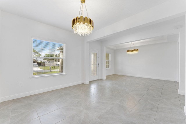 2132 SW Vista Rd, Port Saint Lucie, FL 34953 - unfurnished room with light tile patterned floors, an inviting chandelier, and baseboards