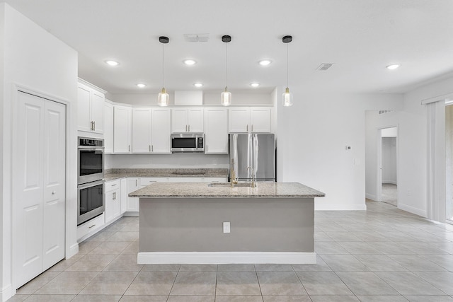 2132 SW Vista Rd, Port Saint Lucie, FL 34953 - kitchen with white cabinets, visible vents, stainless steel appliances, and light tile patterned flooring
