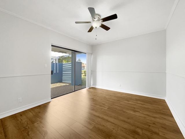 unfurnished room featuring baseboards, wood finished floors, and ceiling fan