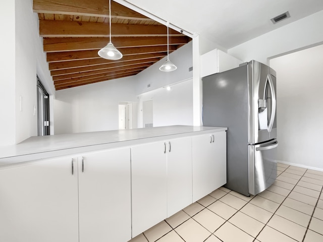 kitchen featuring light tile patterned floors, white cabinets, decorative light fixtures, stainless steel refrigerator with ice dispenser, and vaulted ceiling with beams