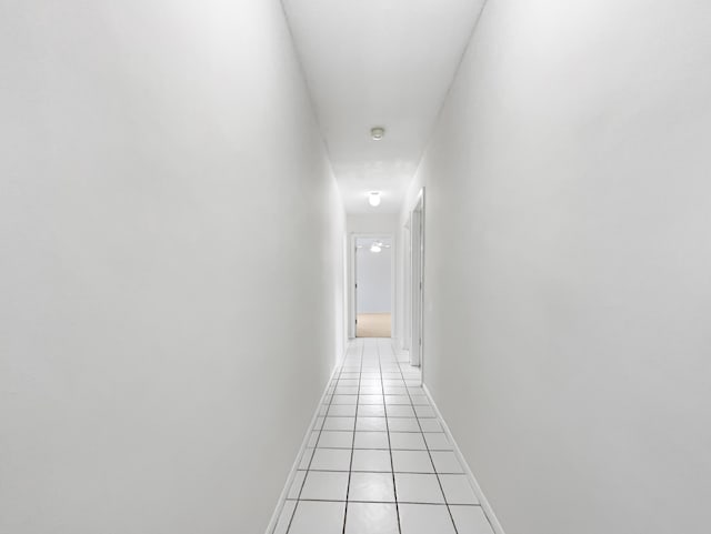 hall with light tile patterned floors