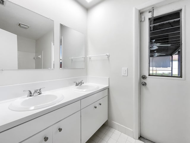 full bath with tile patterned floors, a sink, double vanity, and visible vents