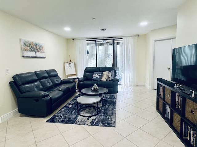 living area with light tile patterned floors, recessed lighting, visible vents, and baseboards