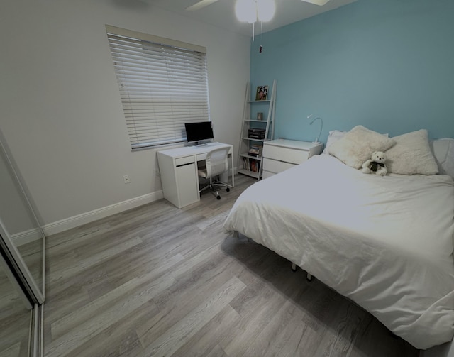 bedroom with light wood-style flooring and baseboards
