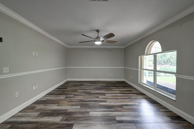 unfurnished room featuring baseboards, a ceiling fan, dark wood finished floors, and crown molding