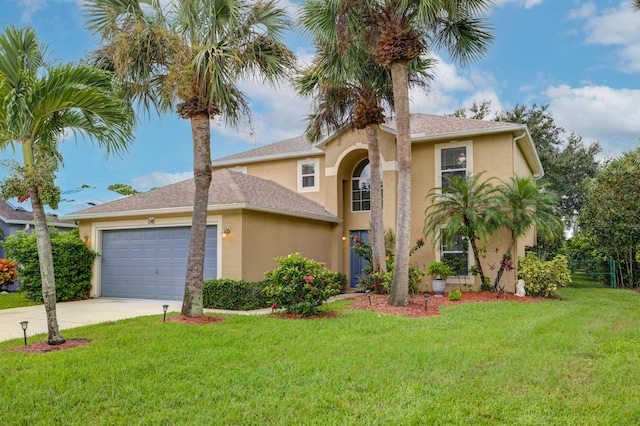 view of front of property with a front yard, stucco siding, concrete driveway, an attached garage, and fence