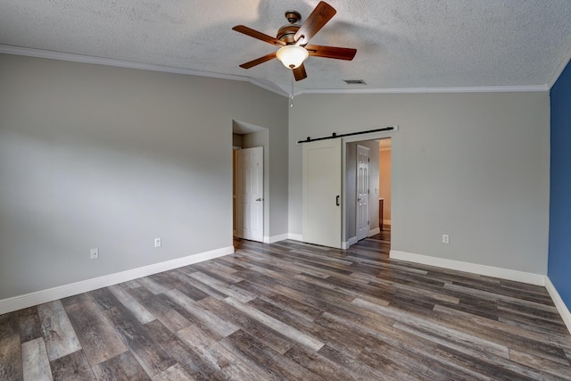 unfurnished bedroom with a textured ceiling, visible vents, vaulted ceiling, and baseboards